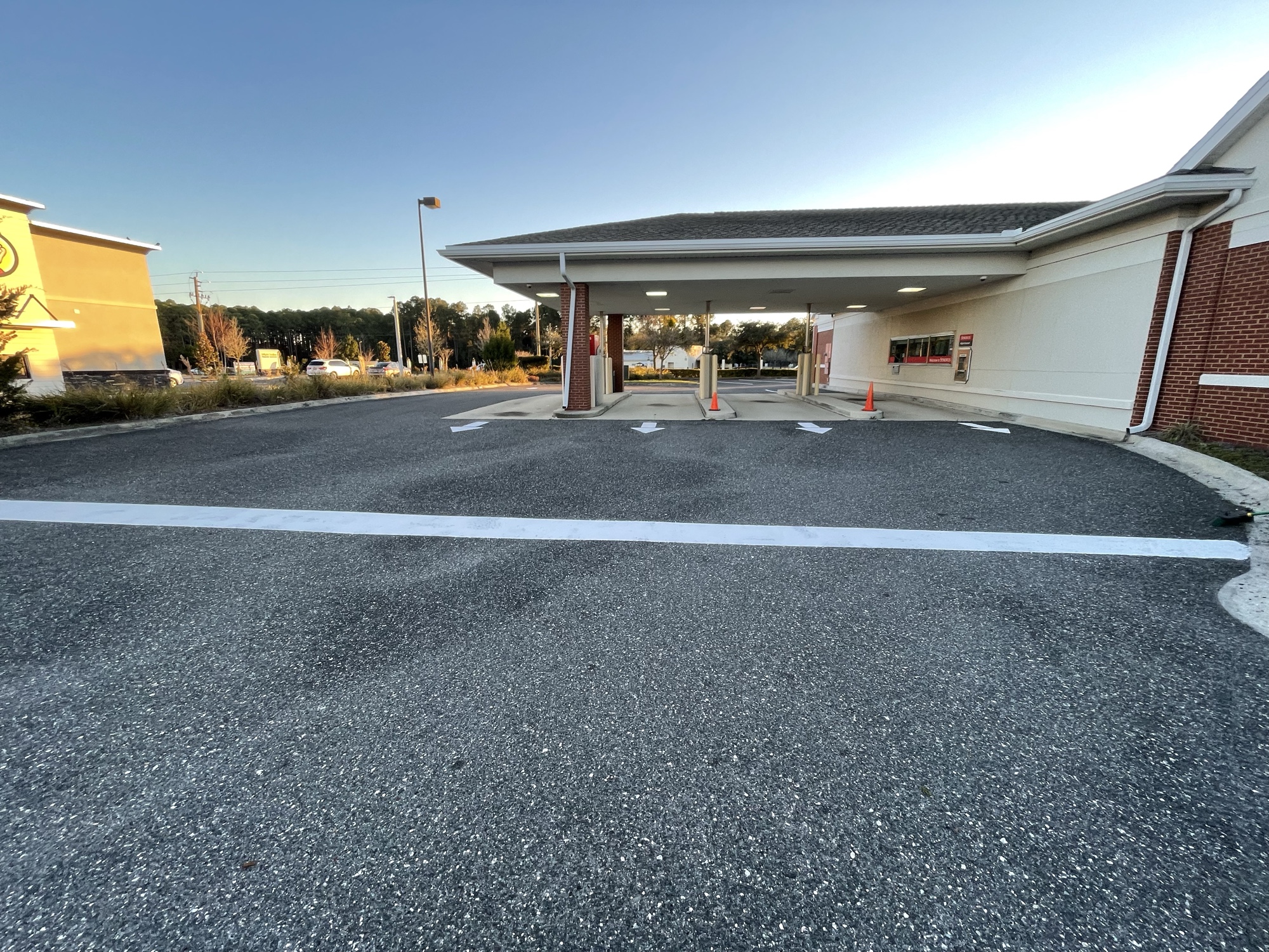 Freshly striped drive-through lane with directional arrows and clean asphalt