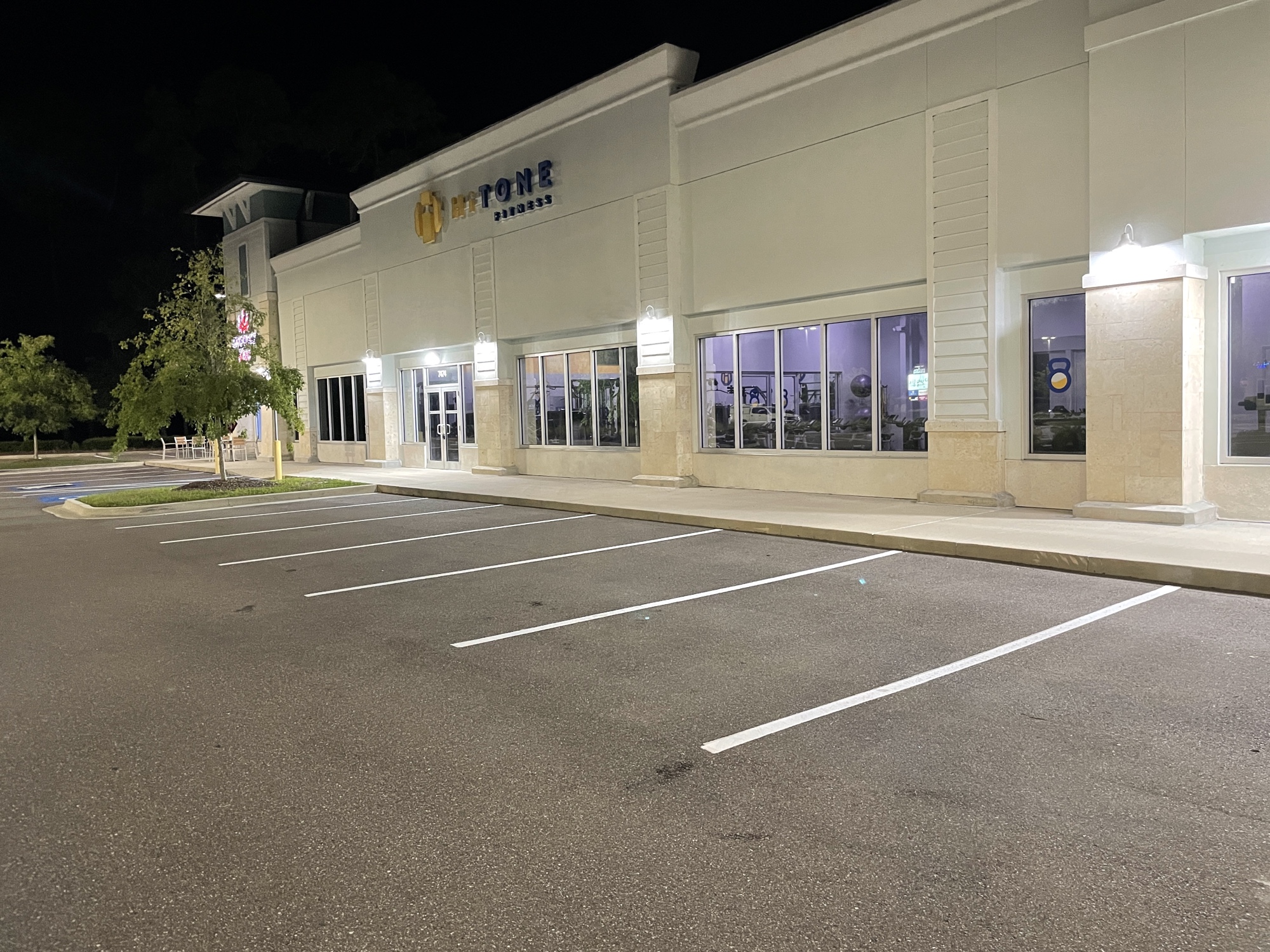 Large commercial shopping center lot with fresh white stripe lines at night