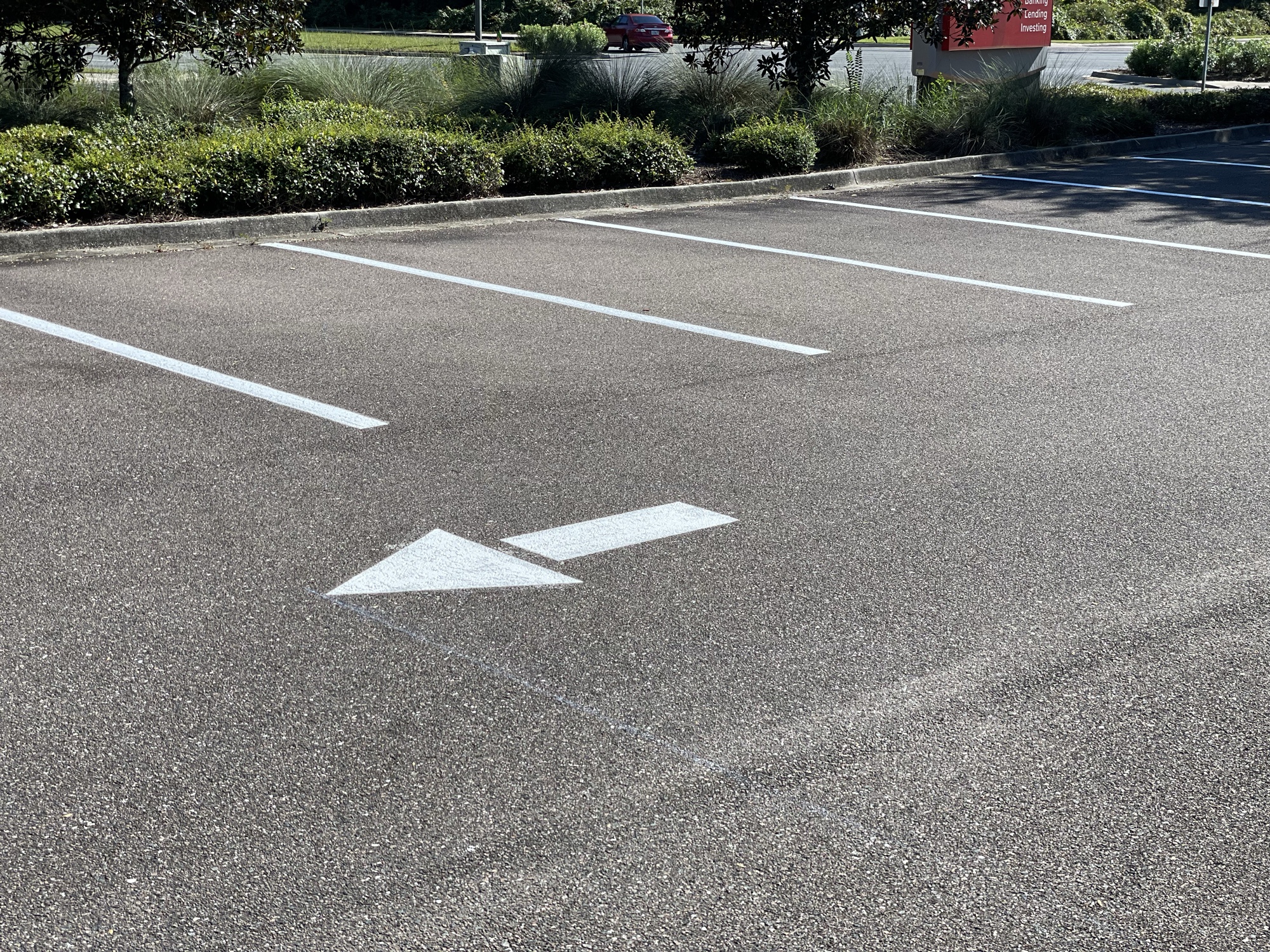 Freshly striped parking lot with directional arrows at night