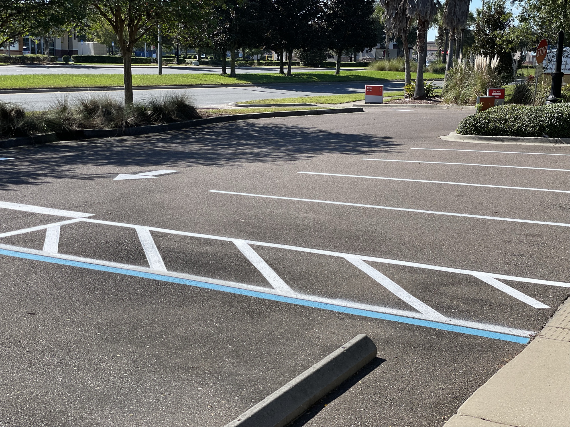 Large commercial lot with crisp white lines and palm trees, Jacksonville FL